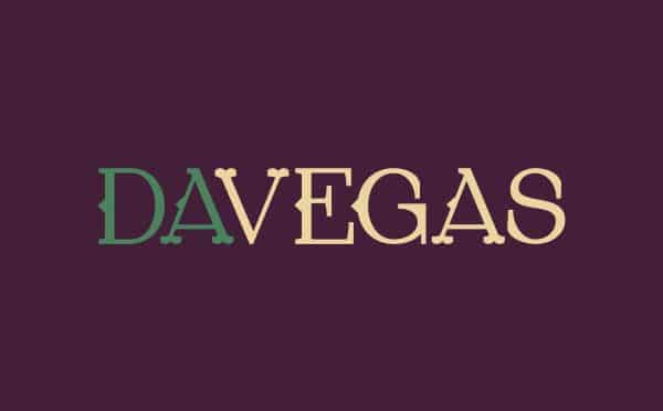 DaVegas Horizontal Logo. Green and beige letters against purple backdrop.